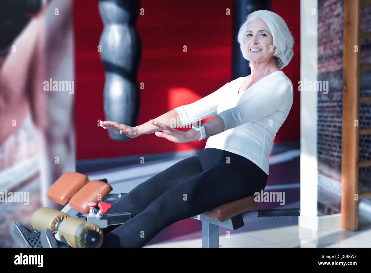 Senior woman doing abs on machiche Stock Photo - Alamy
