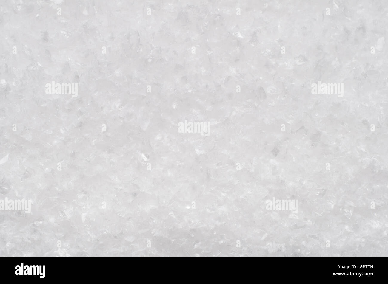 A background texture of artifical snow with icy fragments. Stock Photo