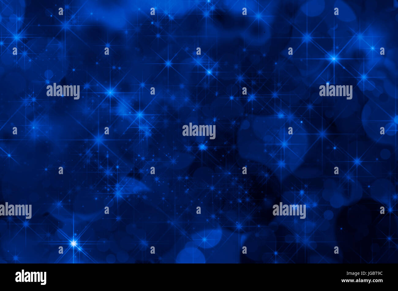 A magical dark blue space (cosmos) background filled with stars and bokeh effects. Stock Photo