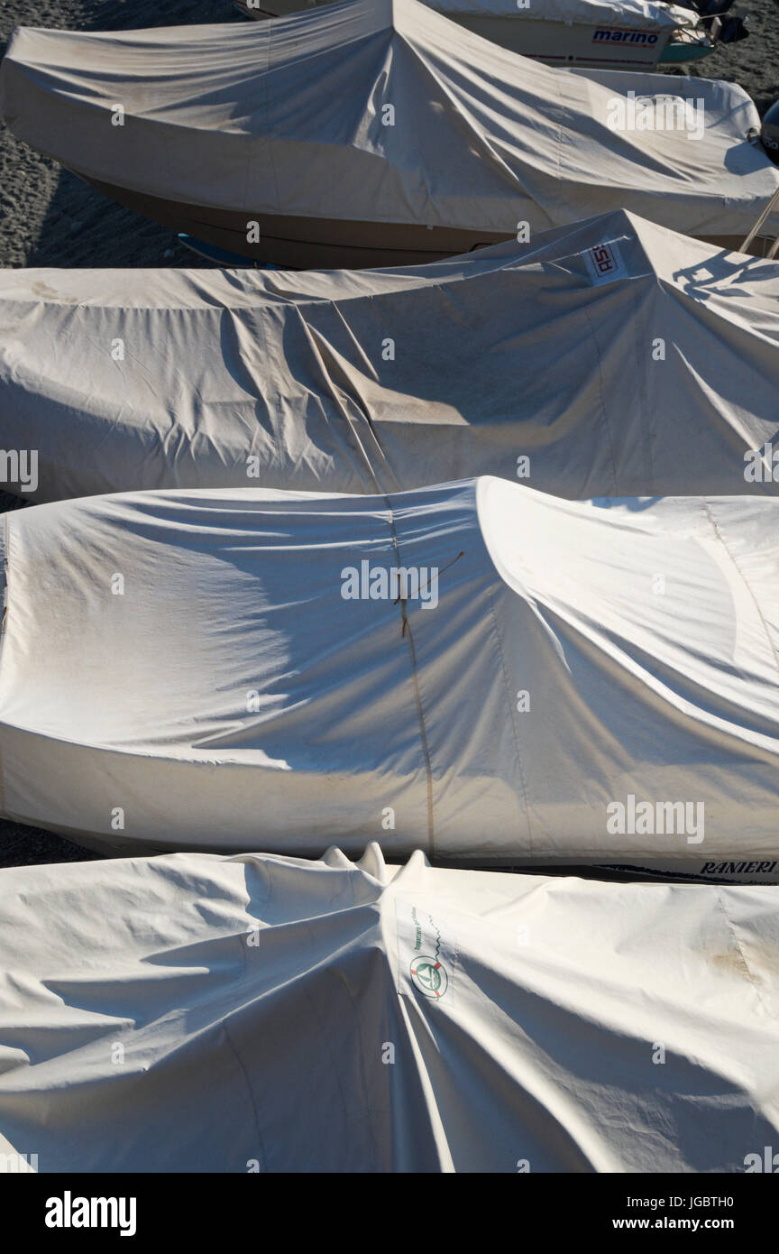 Boats covered in tarps in the off season, Liguria, Italy Stock Photo