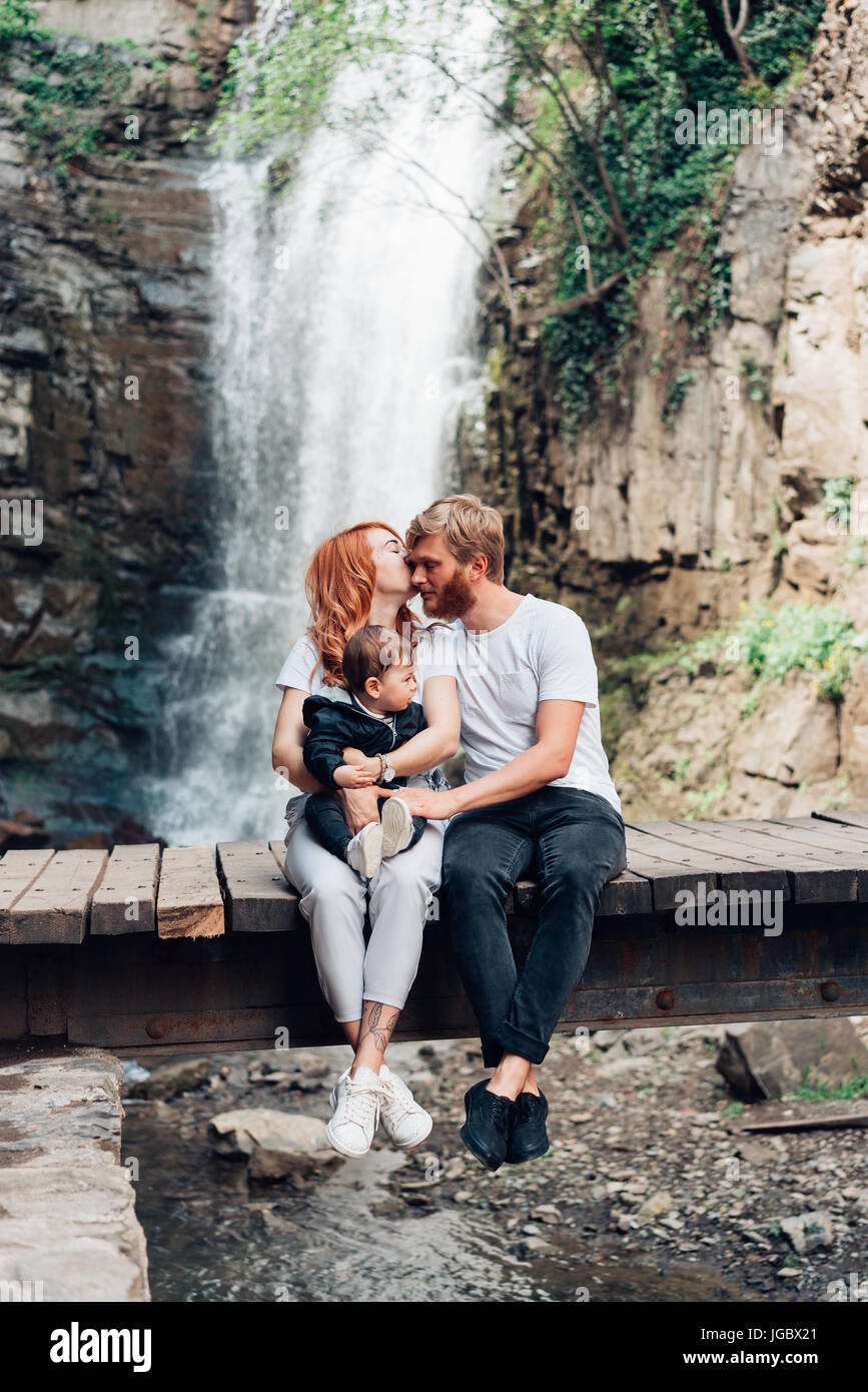 The family is sitting on the bridge Stock Photo - Alamy