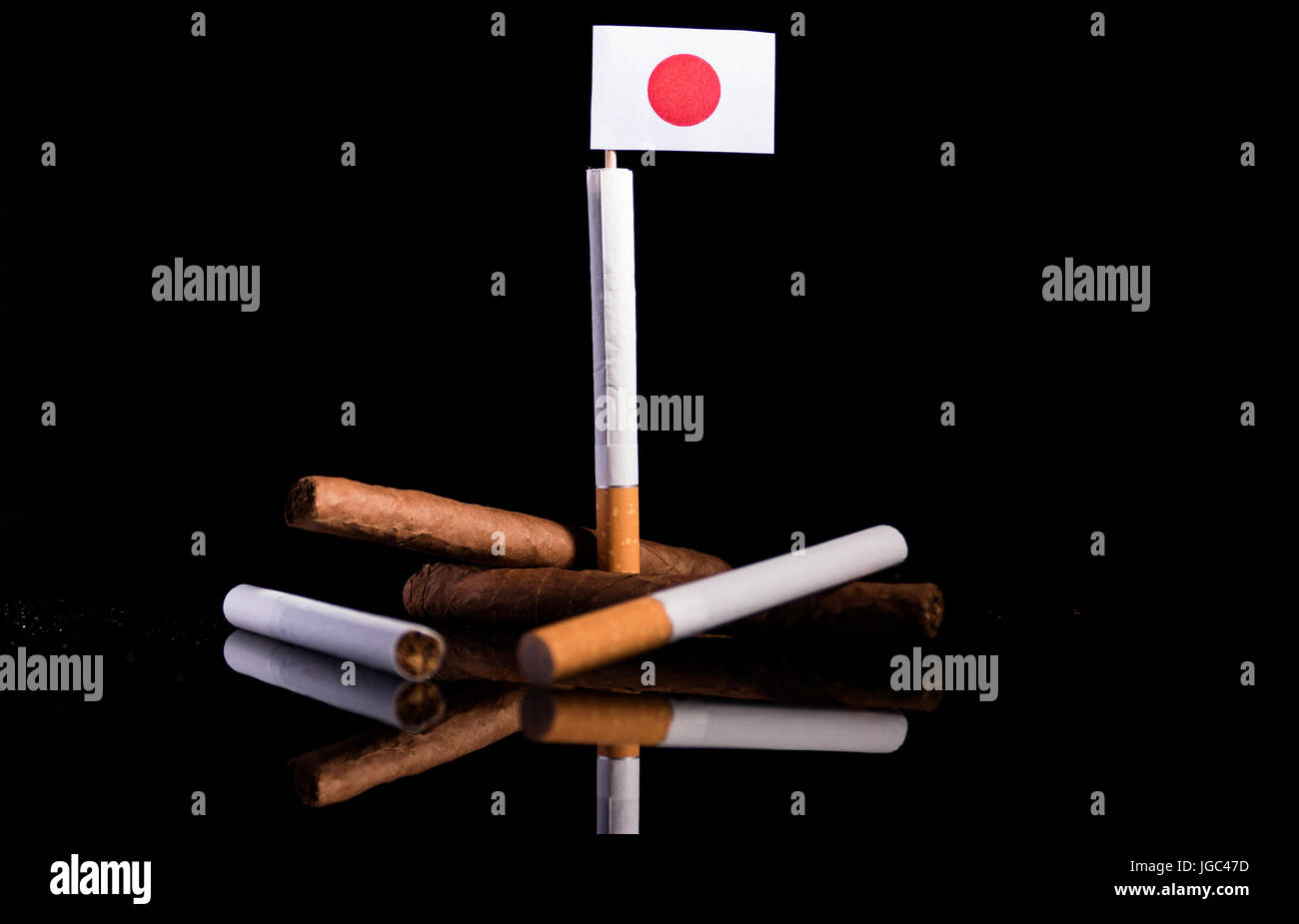 Japanese flag with cigarettes and cigars. Tobacco Industry concept. Stock Photo