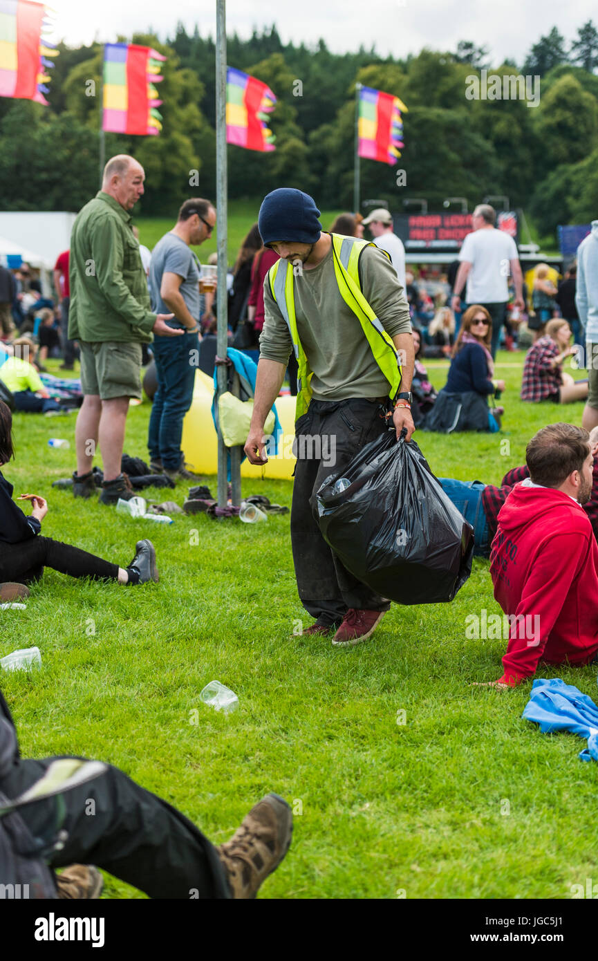 Thornhill, Scotland, UK - August 26, 2016: A litter picker working amongst festival goers in the main arena of the Electric Fields festival Stock Photo