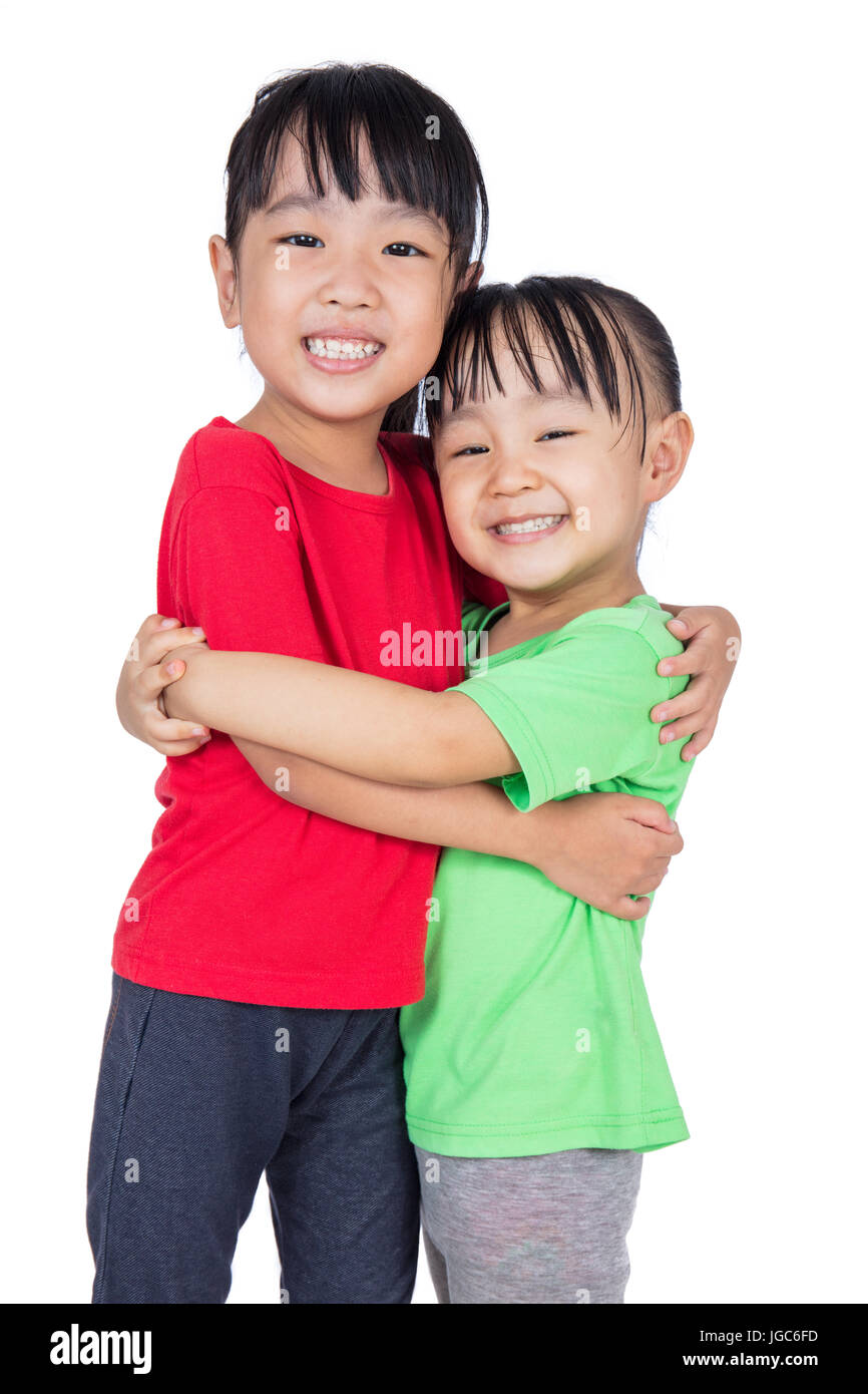Asian Chinese little girls hugging each other in isolated white