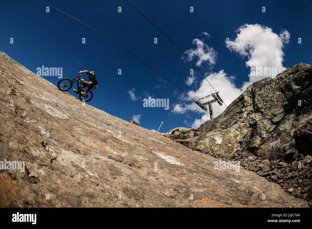 Slab Rides A mountain biker rides across a smooth rock slab in the mountain resort ...