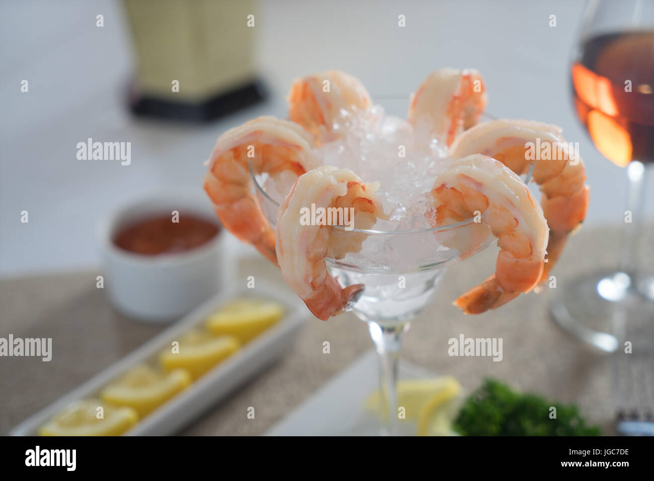 Fresh shrimp cocktail in ice with cocktail sauce, lemon and wine Stock Photo