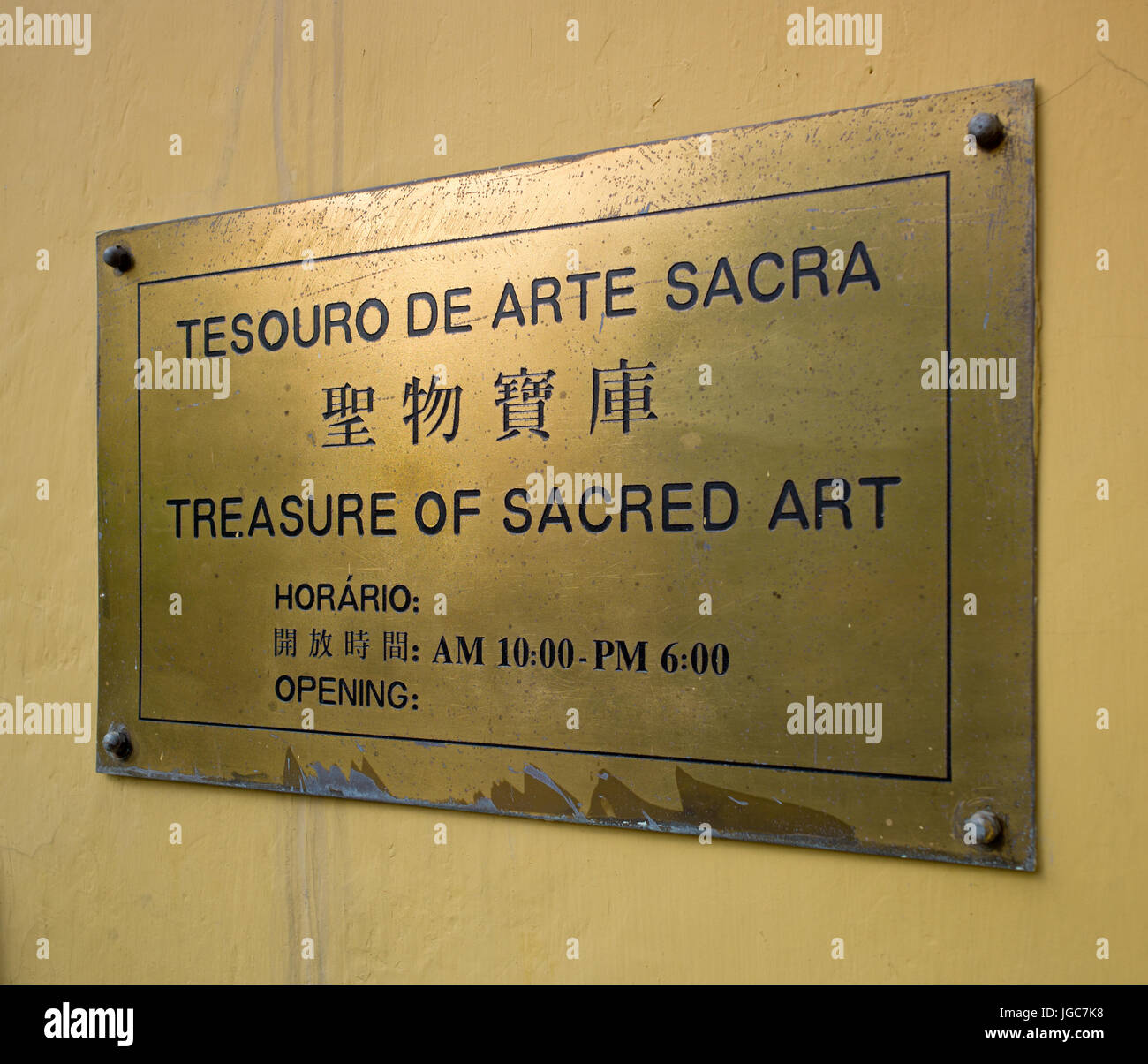 Trilingual brass nameplate at entrance to Tesouro de arte sacra / Treasure of Sacred Art. Macau Stock Photo