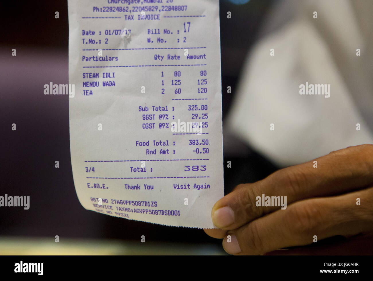 Mumbai, Maharashtra, India. 1st July, 2017. 1 July 2017 : Mumbai - INDIA.A waiter shows the New Tax invoice for food which includes 18% GST tax.As a result of GST Restaurant food has become expensive.The new GST tax, designed to replace India's labyrinth of various levies found across the country's states with a uniform system and unite India into a single market, was launched by the country's prime minister Narendra Modi in a special session of parliament in New Delhi at the stroke of midnight 30 June 2017. Credit: Subhash Sharma/ZUMA Wire/Alamy Live News Stock Photo
