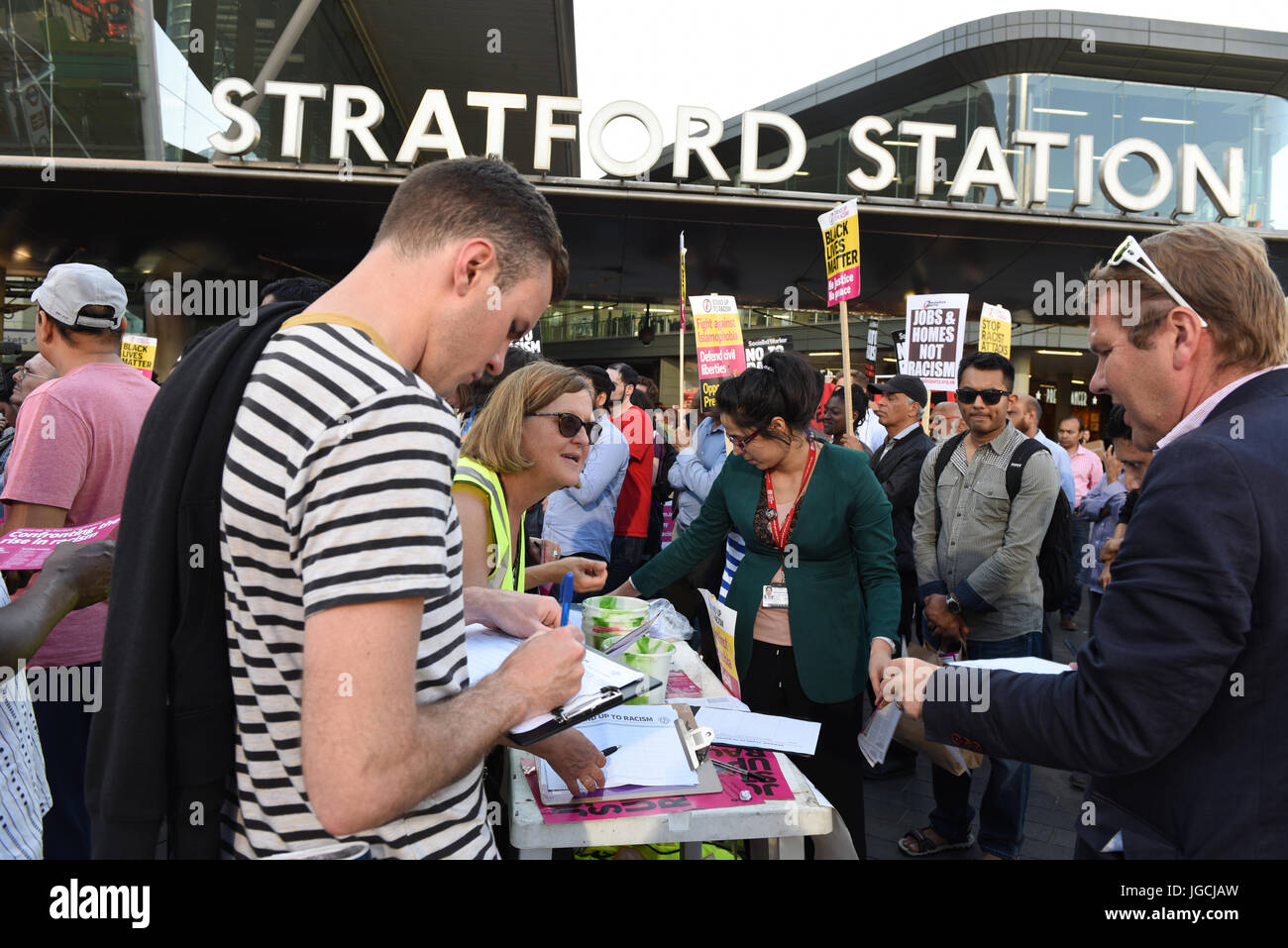 London, UK. 05th JUL 2017. 'STOP ACID ATTACKS' emergency protest outside the Stratford station in East London. Protesters gathered to protest against the recent acid attacks and increasing Islamophobia. The man is signing petition. Credit: ZEN - Zaneta Razaite / Alamy Live News Stock Photo