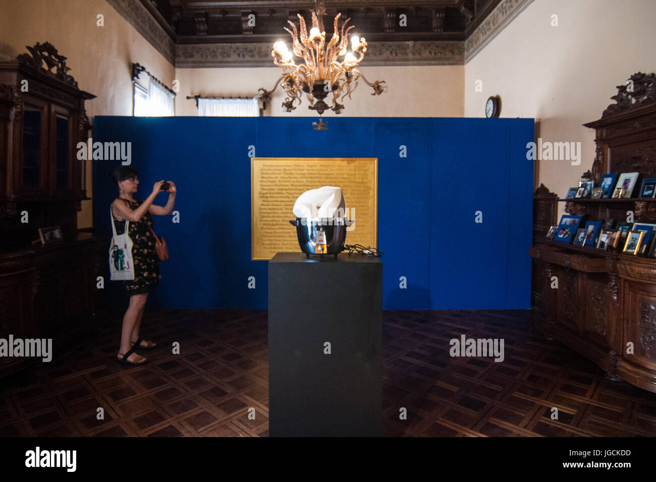 Venice, Italy. 05th July, 2017. A visitor takes a picture of the Diaspora pavilion, where there are photographs on display by artist Khadija Saye, at the Biennale Arte 2017 on July 5, 2017 in Venice, Italy. The work of Khadija Saye, the 24-year-old photographer who died with her mother Mary Mendy in the Grenfell Tower fire in West London last week, is on show in the Diaspora Pavilion at the Venice Biennale in a presentation curated by David A Bailey featuring emerging artists from diverse cultural backgrounds. Credit: Awakening Photo Agency/Alamy Live News Stock Photo