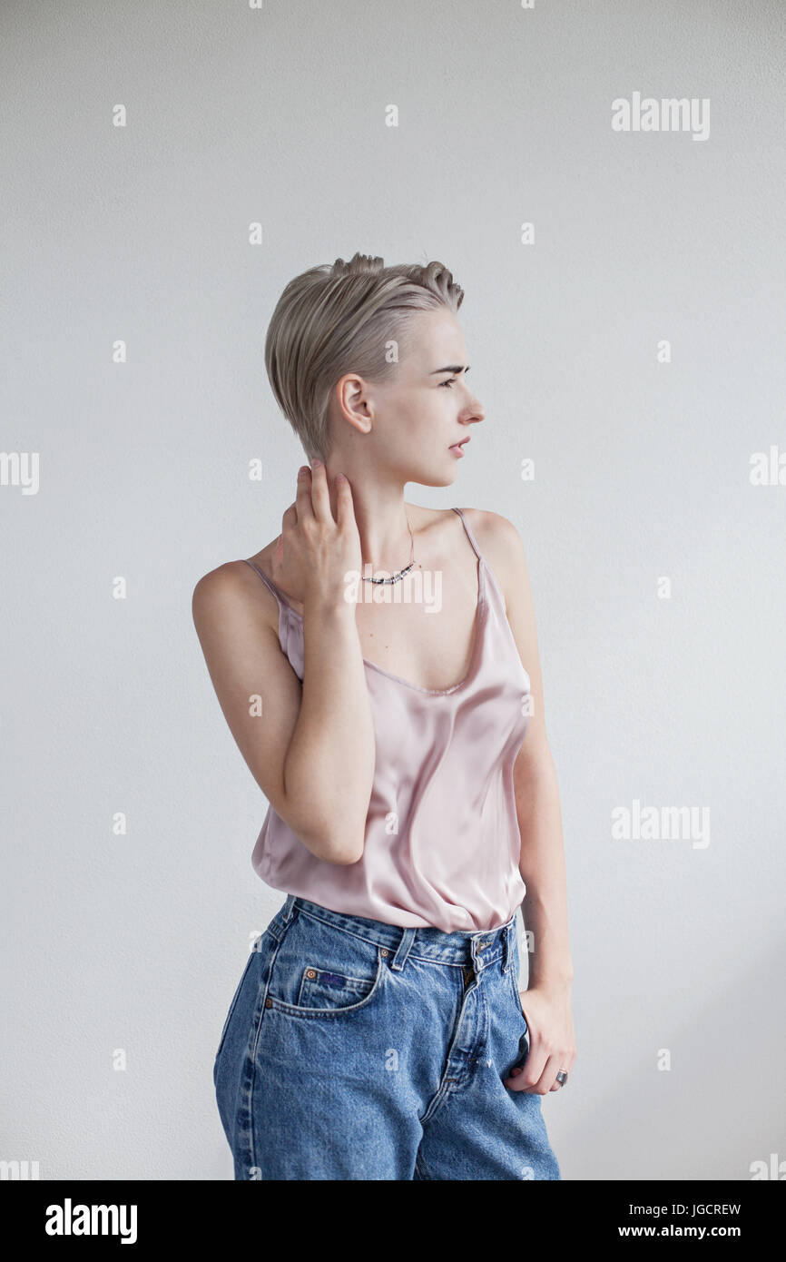 Portrait of a blonde woman with her hand on her neck Stock Photo