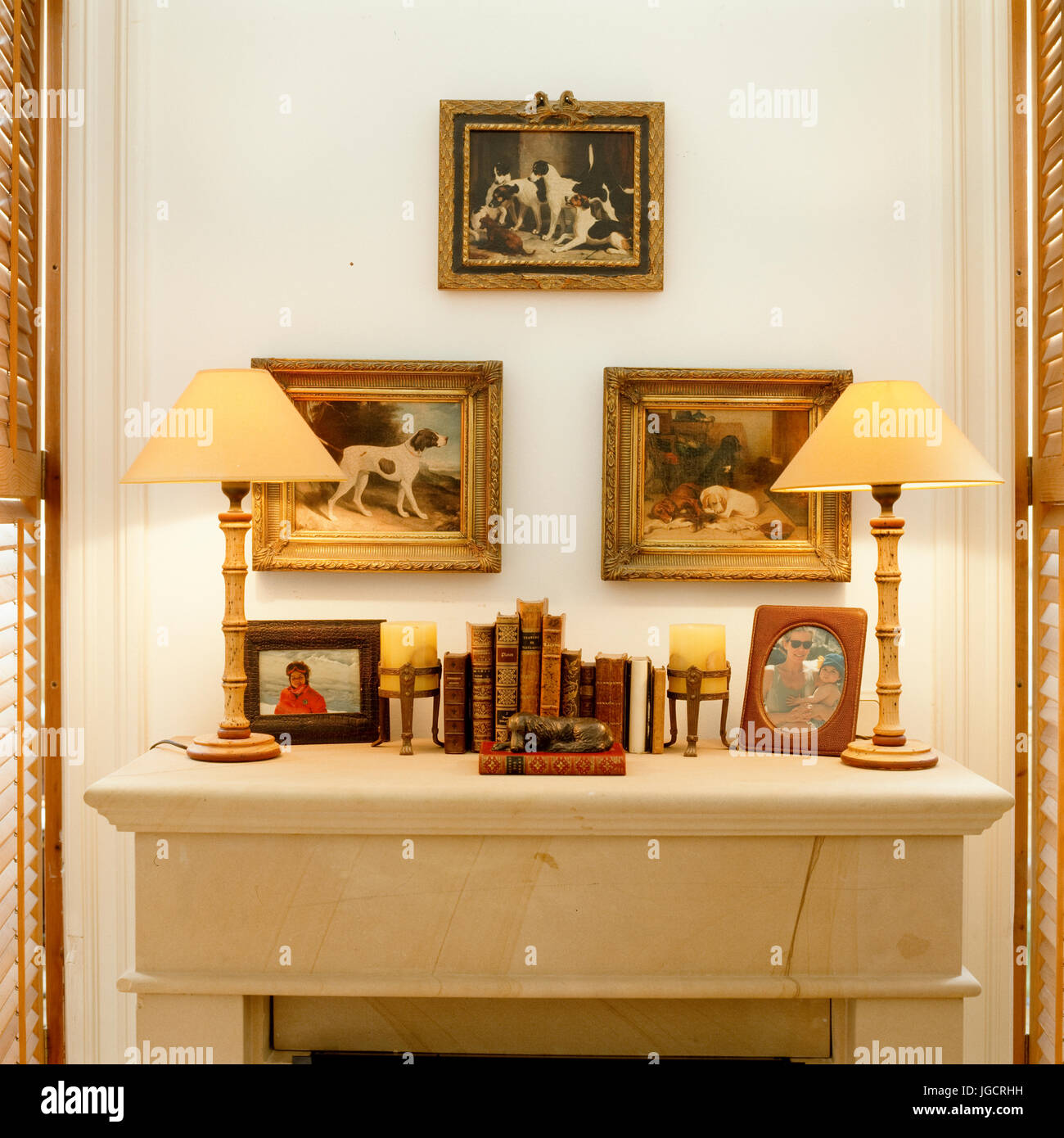 Mantelpiece with vintage lamps and art Stock Photo