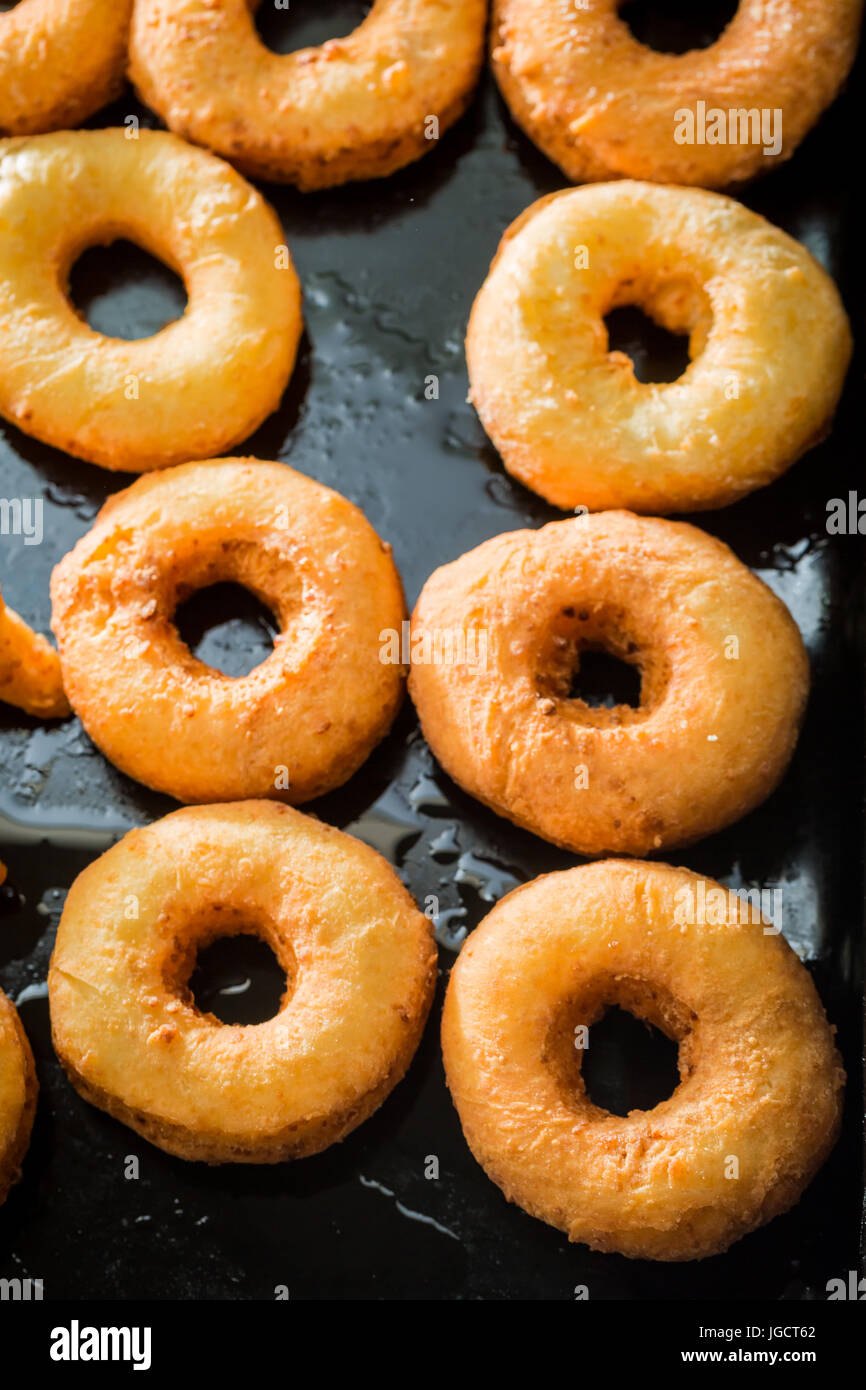 Closeup of sweet golden donuts freshly baked Stock Photo - Alamy