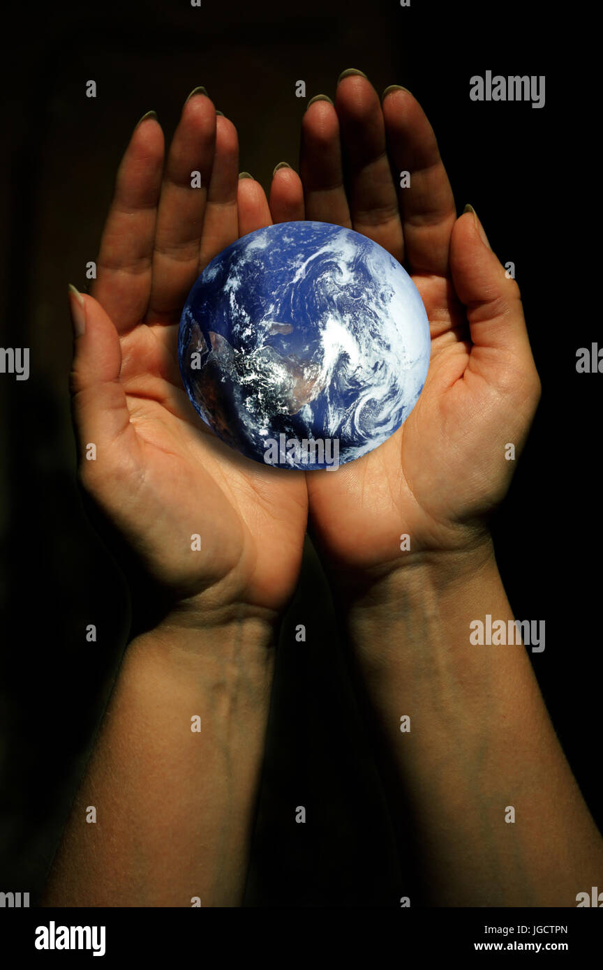 open female hand holding and protecting the planet earth Stock Photo