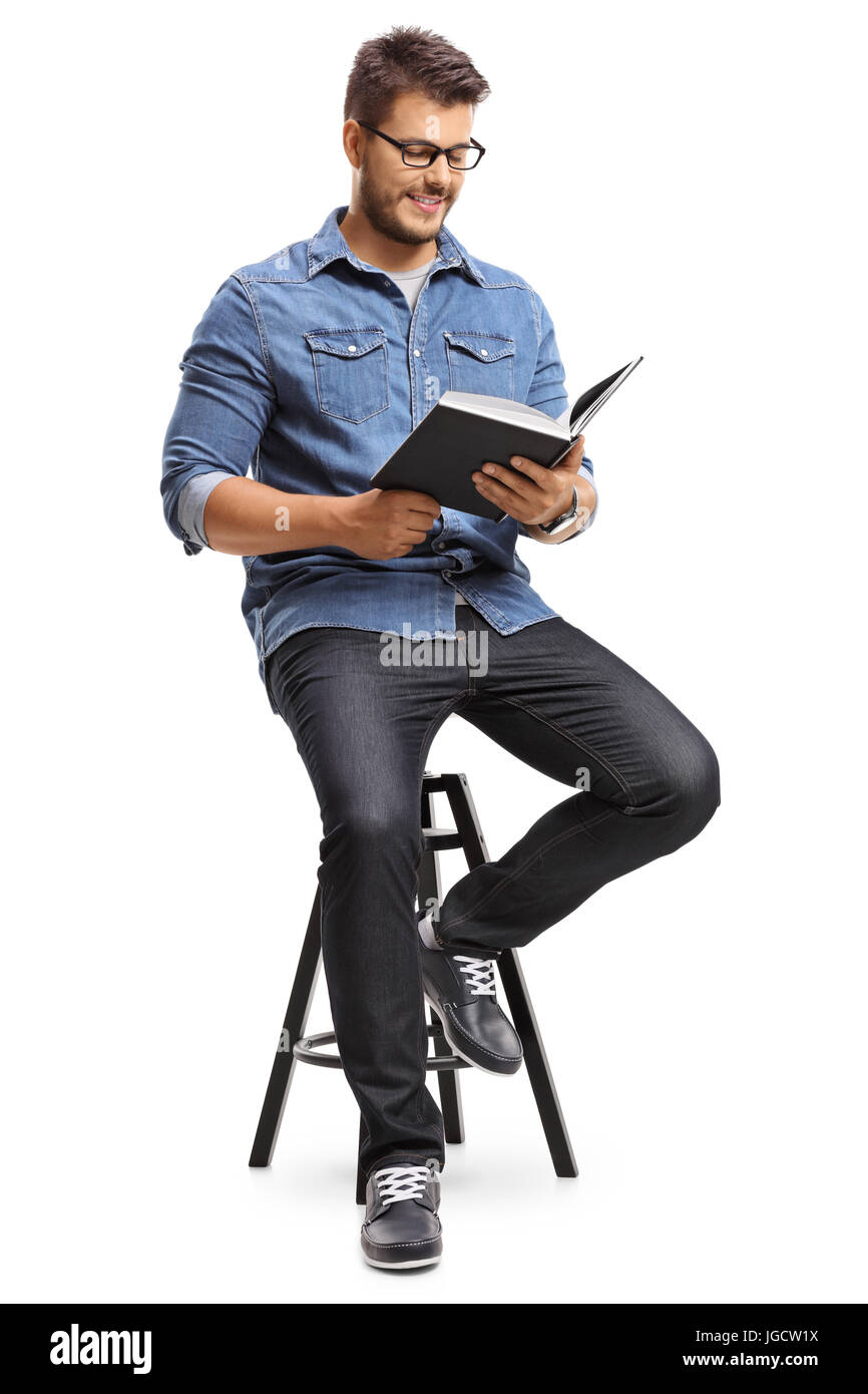 Guy sitting on a chair and reading a book isolated on white background