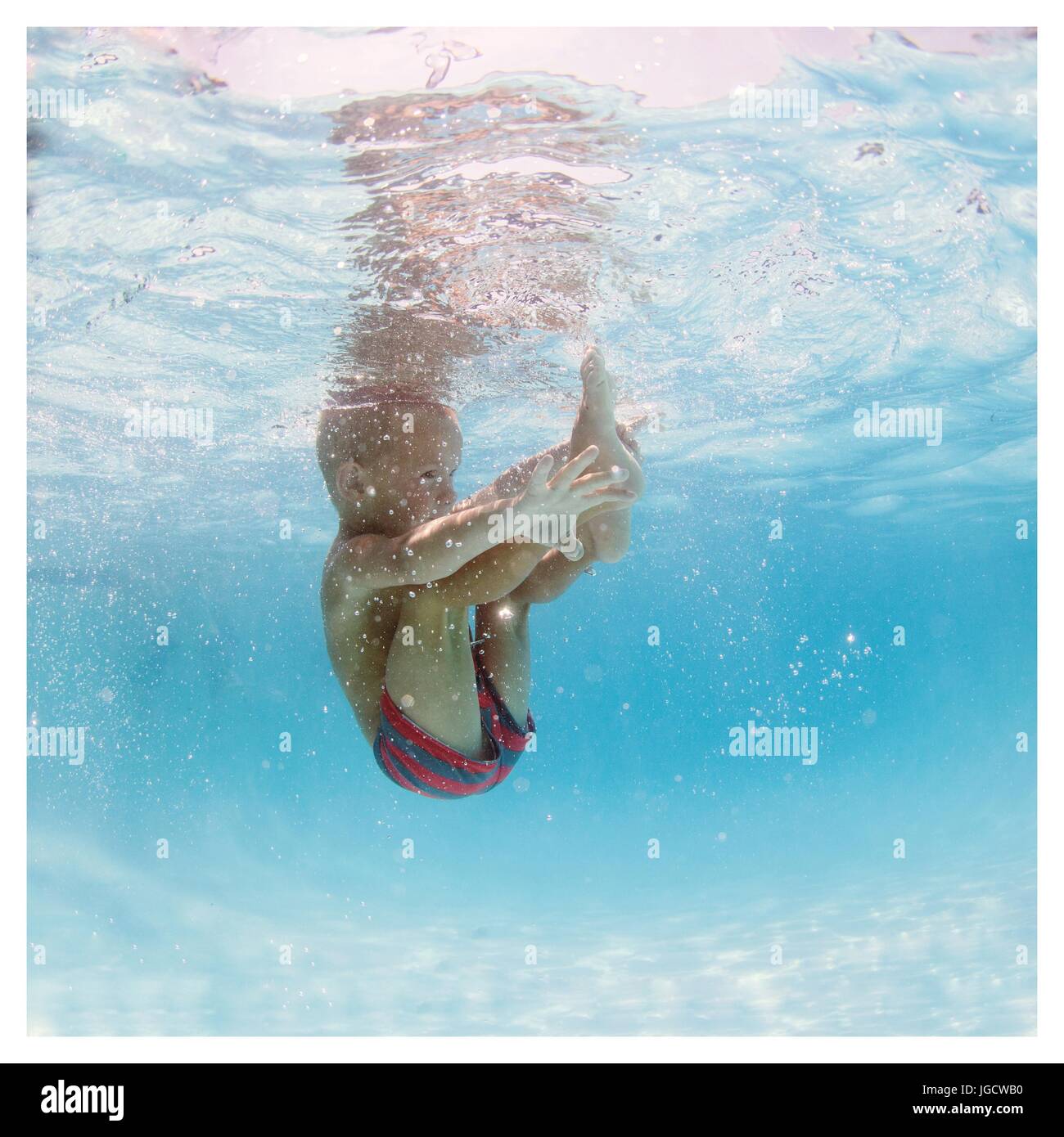 Underwater view of a boy jumping into a swimming pool Stock Photo Alamy