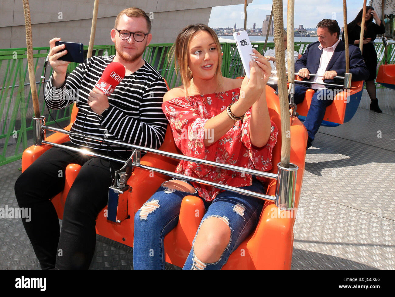 Reality TV Star Charlotte Crosby takes a selfie as she enjoys the funfair at Pier Head Village, Liverpool. Stock Photo