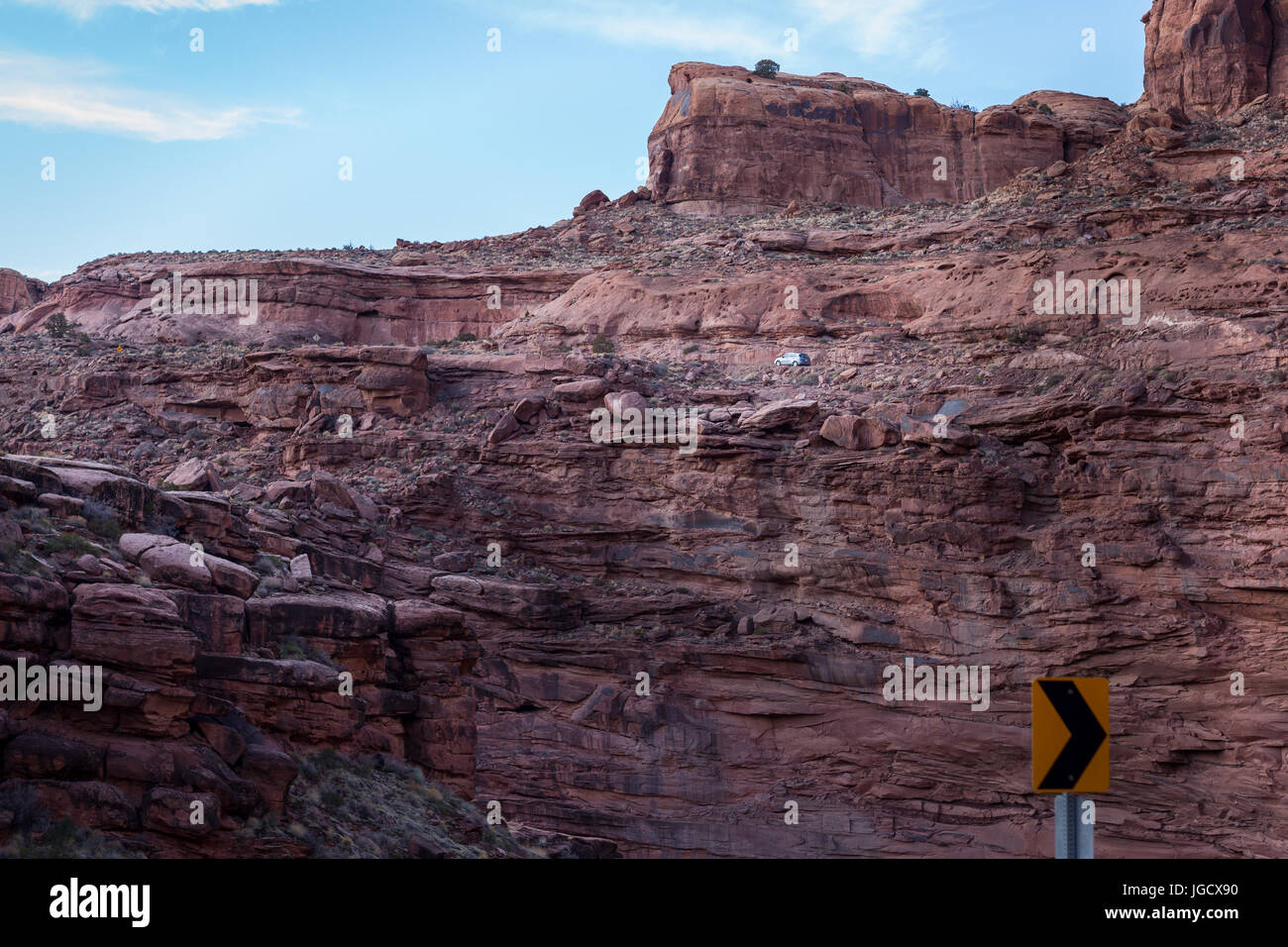Car driving along cliff in desert landscape, America, USA Stock Photo