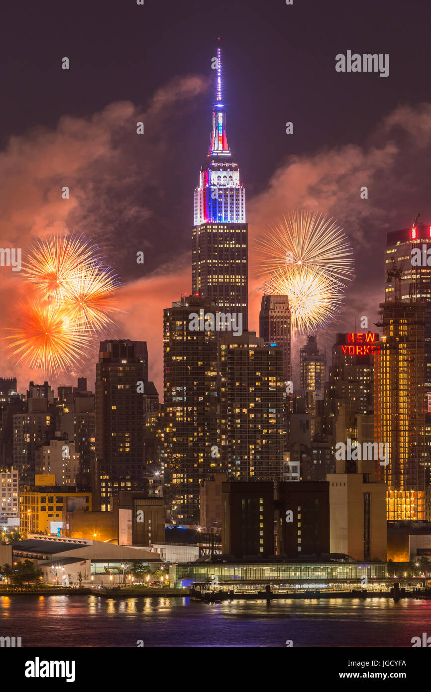 The annual Macy's Fourth of July fireworks show lights the sky behind the Manhattan skyline in New York City as seen from across the Hudson River. Stock Photo