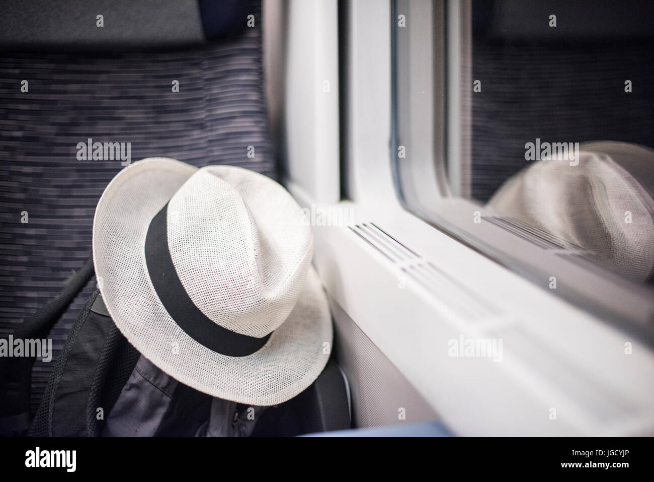 Hat and bag on a train Stock Photo