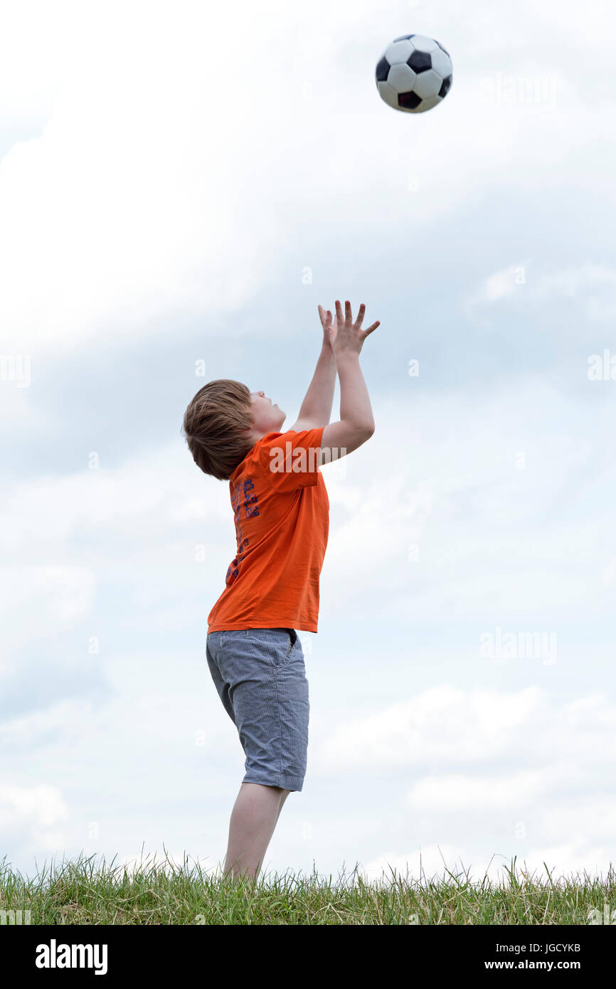 young boy catching a ball Stock Photo