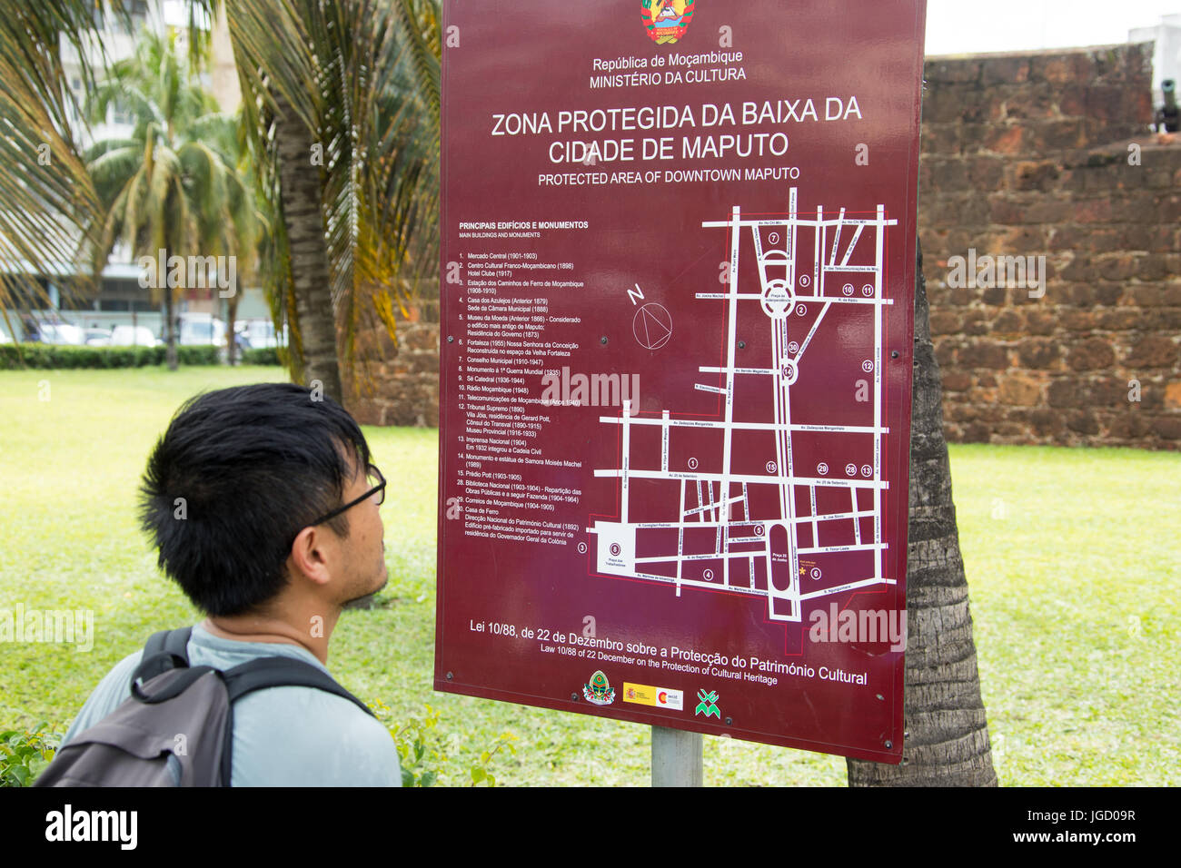 Asian tourist looking at a map of downtown Maputo, Mozambique Stock Photo