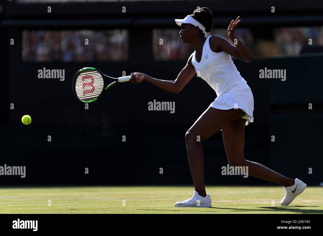 Venus Williams in action against Qiang Wang on day three of the Wimbledon Championships at The All England Lawn Tennis and Croquet Club, Wimbledon. Stock Photo