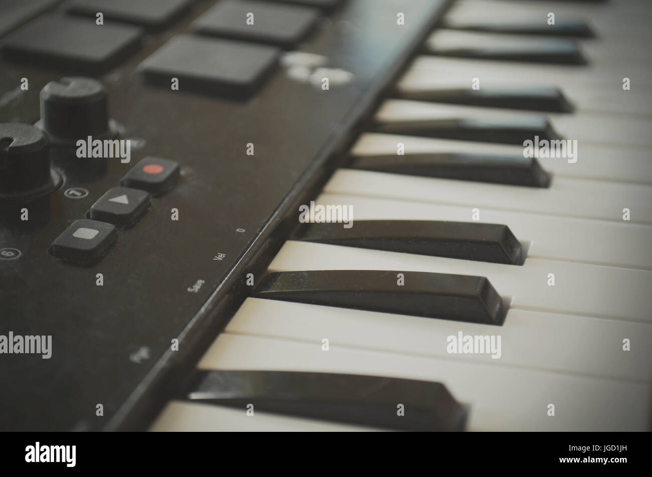 Piano or electone midi keyboard, electronic musical synthesizer white and black key. Vintage effect, instagram filter style. Stock Photo