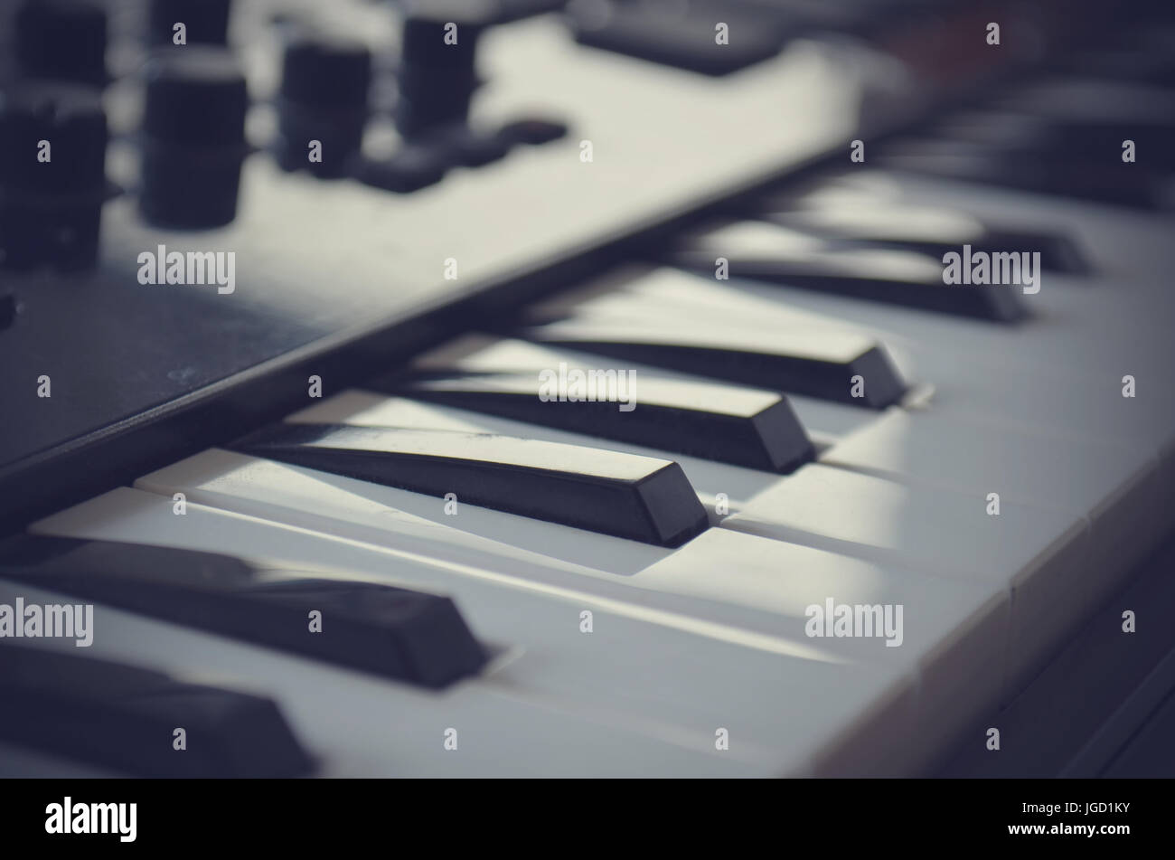 Piano or electone midi keyboard, electronic musical synthesizer white and black key. Vintage effect, instagram filter style. Stock Photo