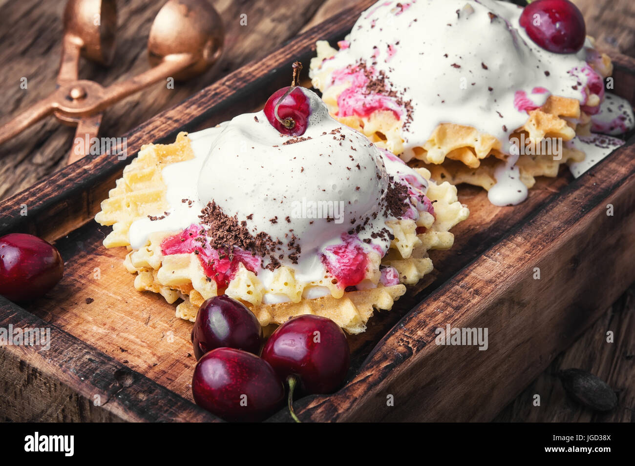 Ice cream on baked wafers with cherries Stock Photo