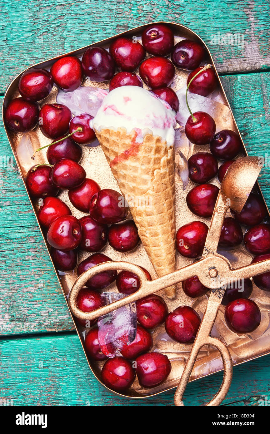 Ice cream in a waffle with cherry on stylish background Stock Photo