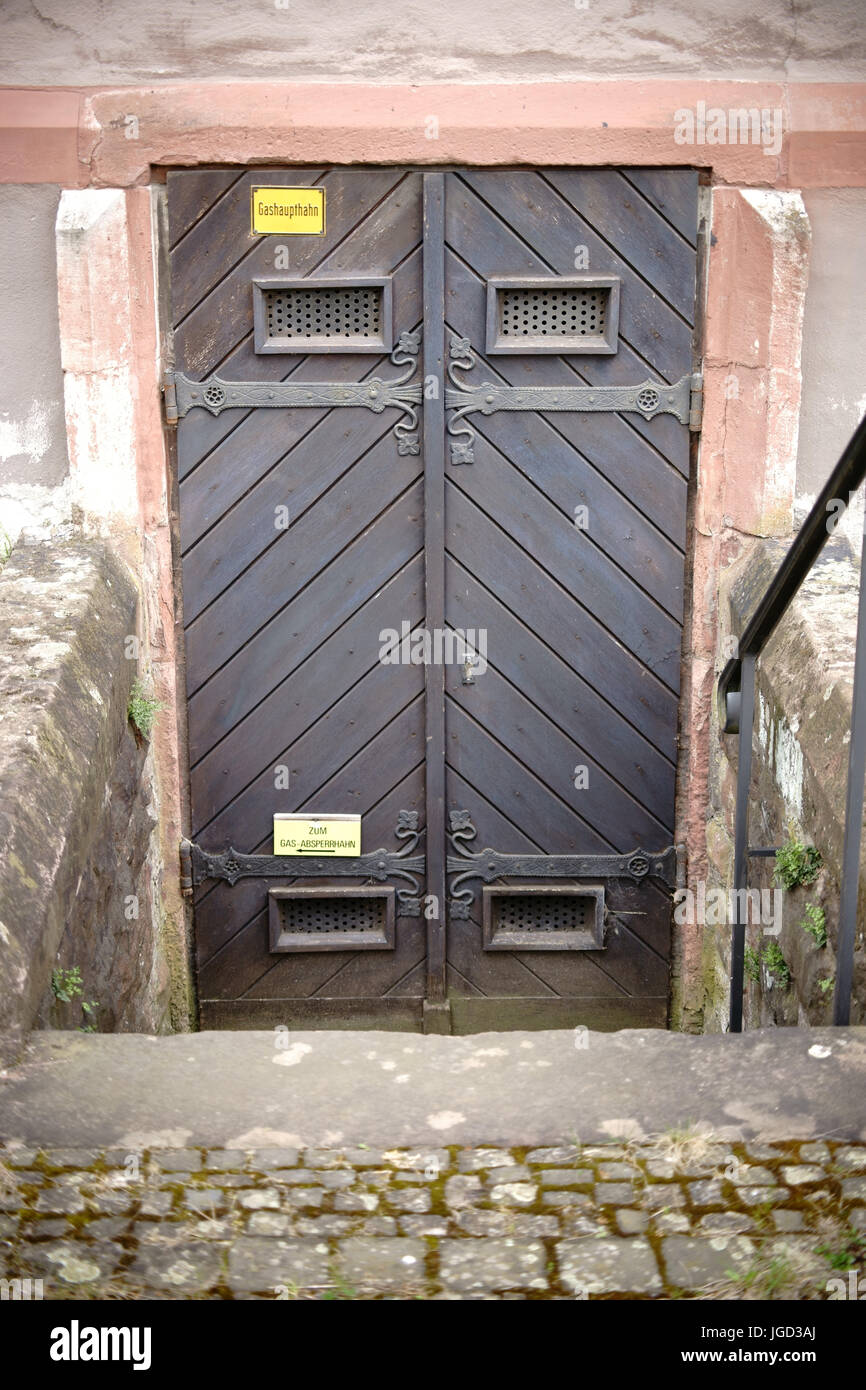 A heavy wooden church door with wrought-iron hinges. Stock Photo