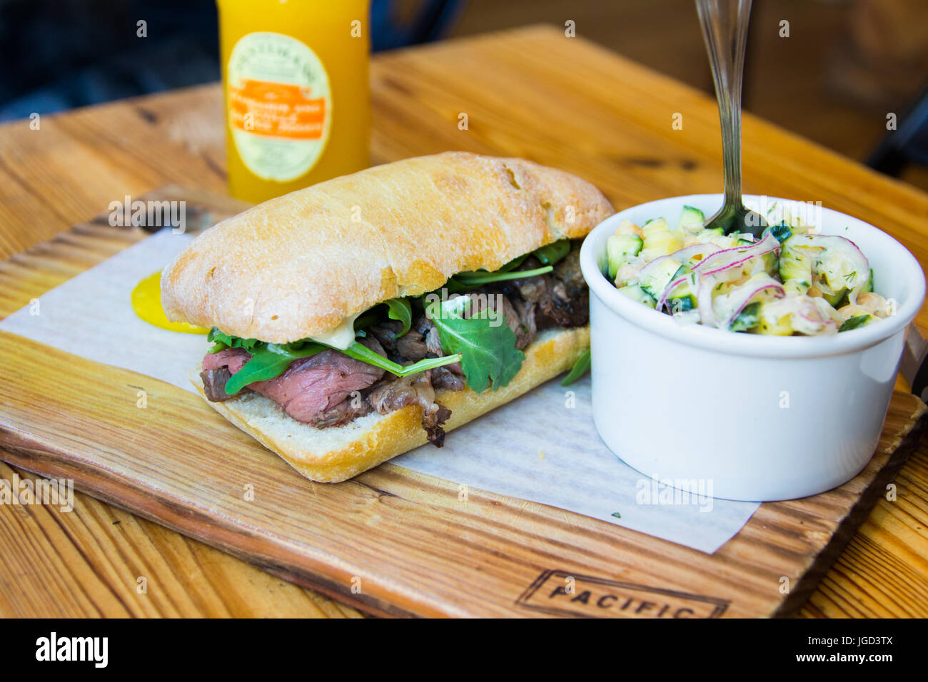 Prime rib, arugula, and garlic mayo sandwich, zucchini chickpea salad at Meat and Bread Restaurant, Gastown, Vancouver, Canada Stock Photo