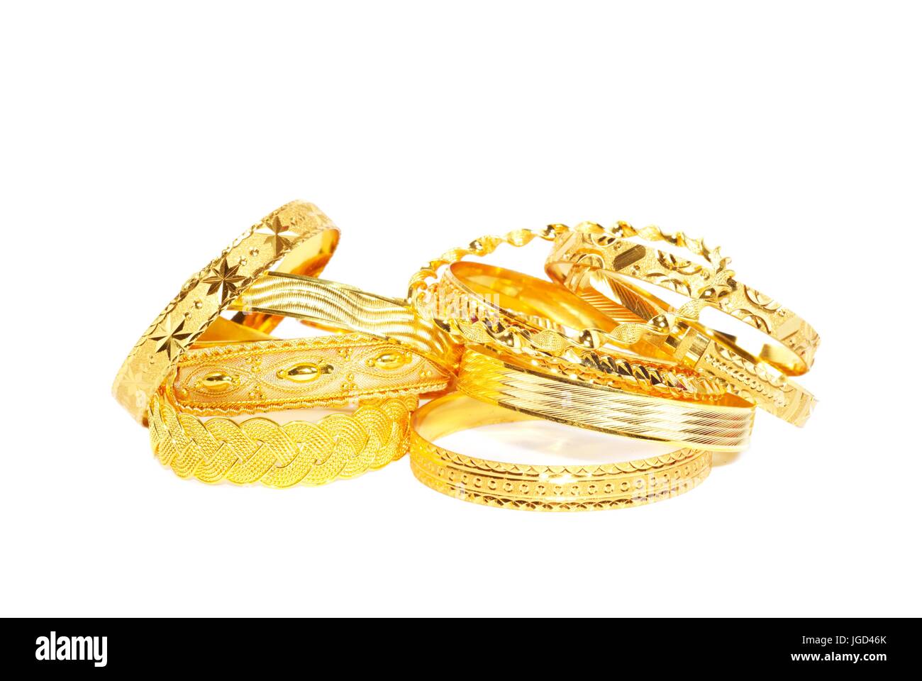 Gold bracelets on white Stock Photo Alamy