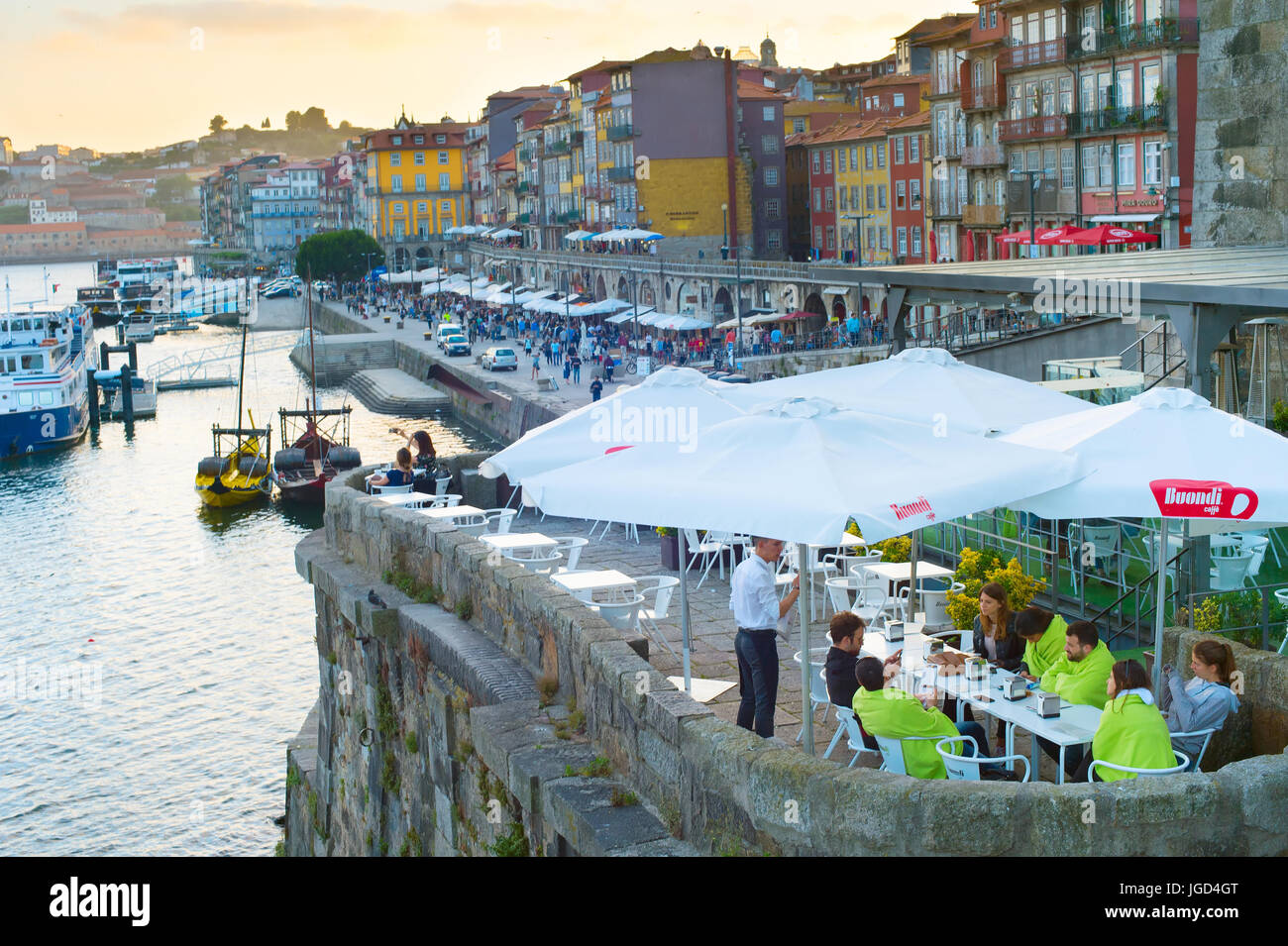 PORTO, PORTUGAL - JUNE 01, 2017: People at street reataurant on quayside of Porto. About 10 million tourist visit Portugal every year. Stock Photo