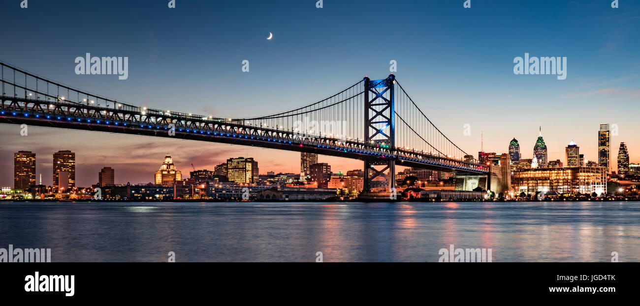 Philadelphia skyine and Benjamin Franklin Bridge at dusk as seen from Camden, New Jersey Stock Photo