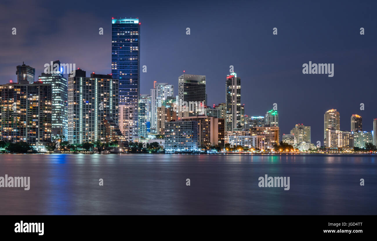 Miami waterfront skyline at night across Biscayne Bay from the Rickenbacker Causeway Stock Photo