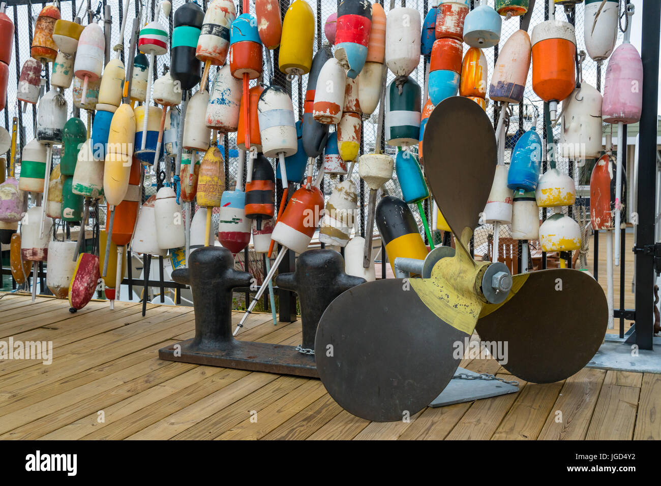 Collection of Lobster Buoys Hanging on a Fence with propeller Stock Photo