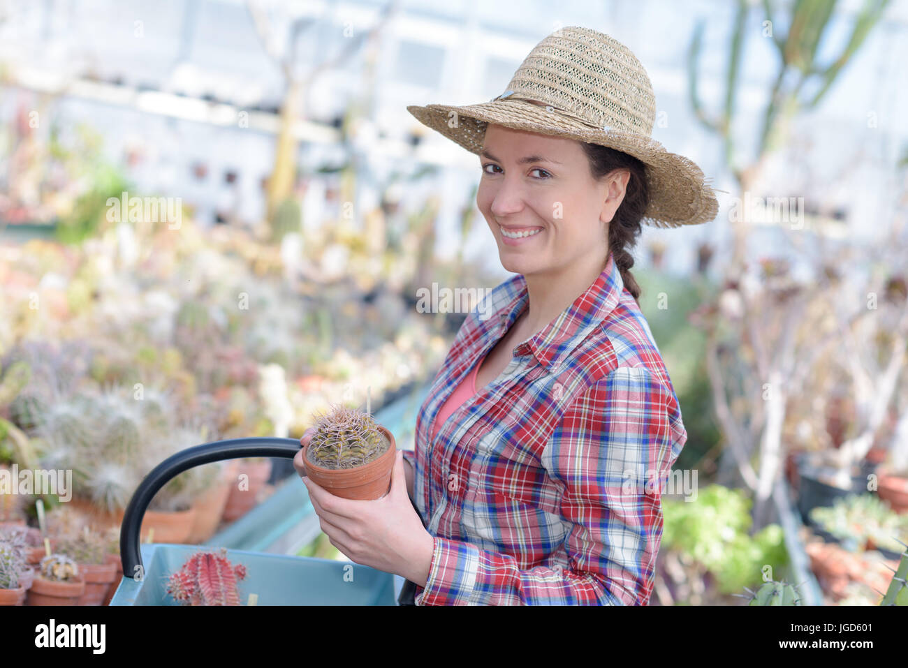 florists woman holding flowers in her garden and smiling Stock Photo ...