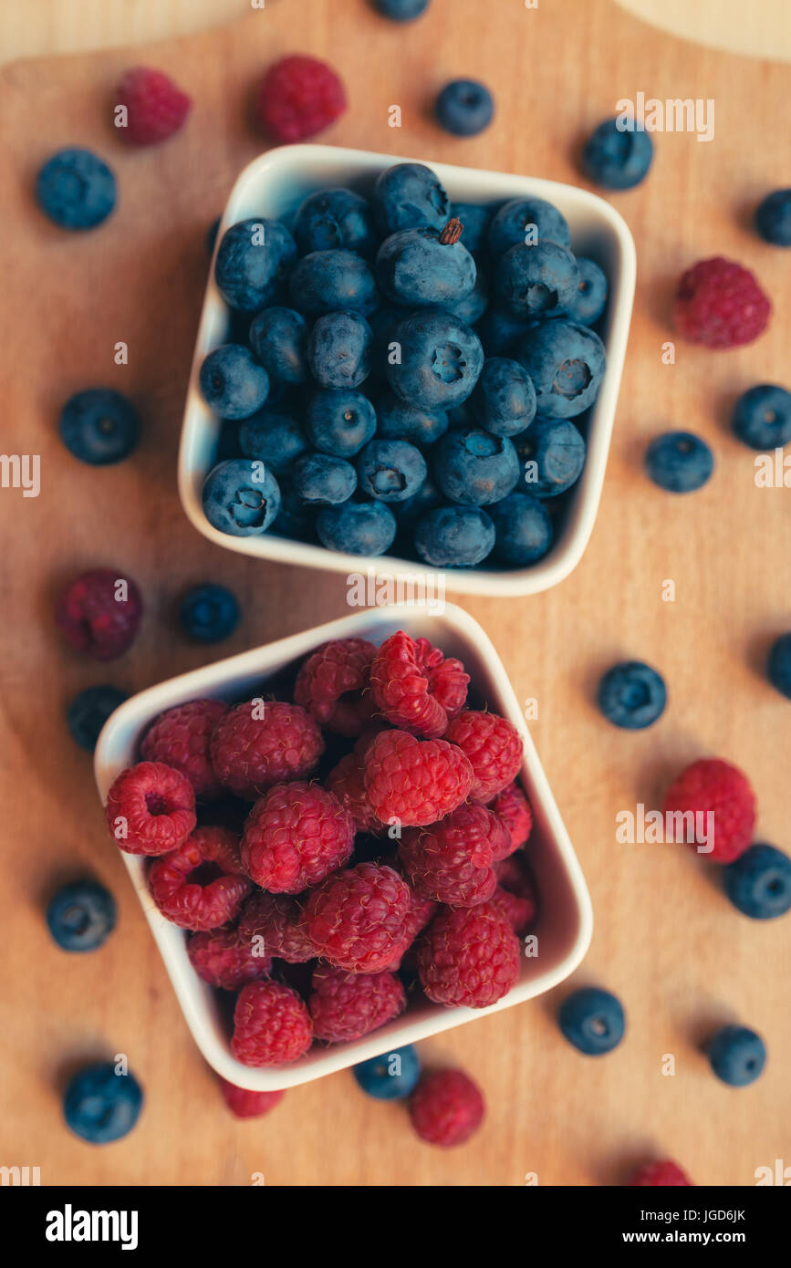 Blueberries and raspberries, healthy forest berry fruit, selective focus Stock Photo