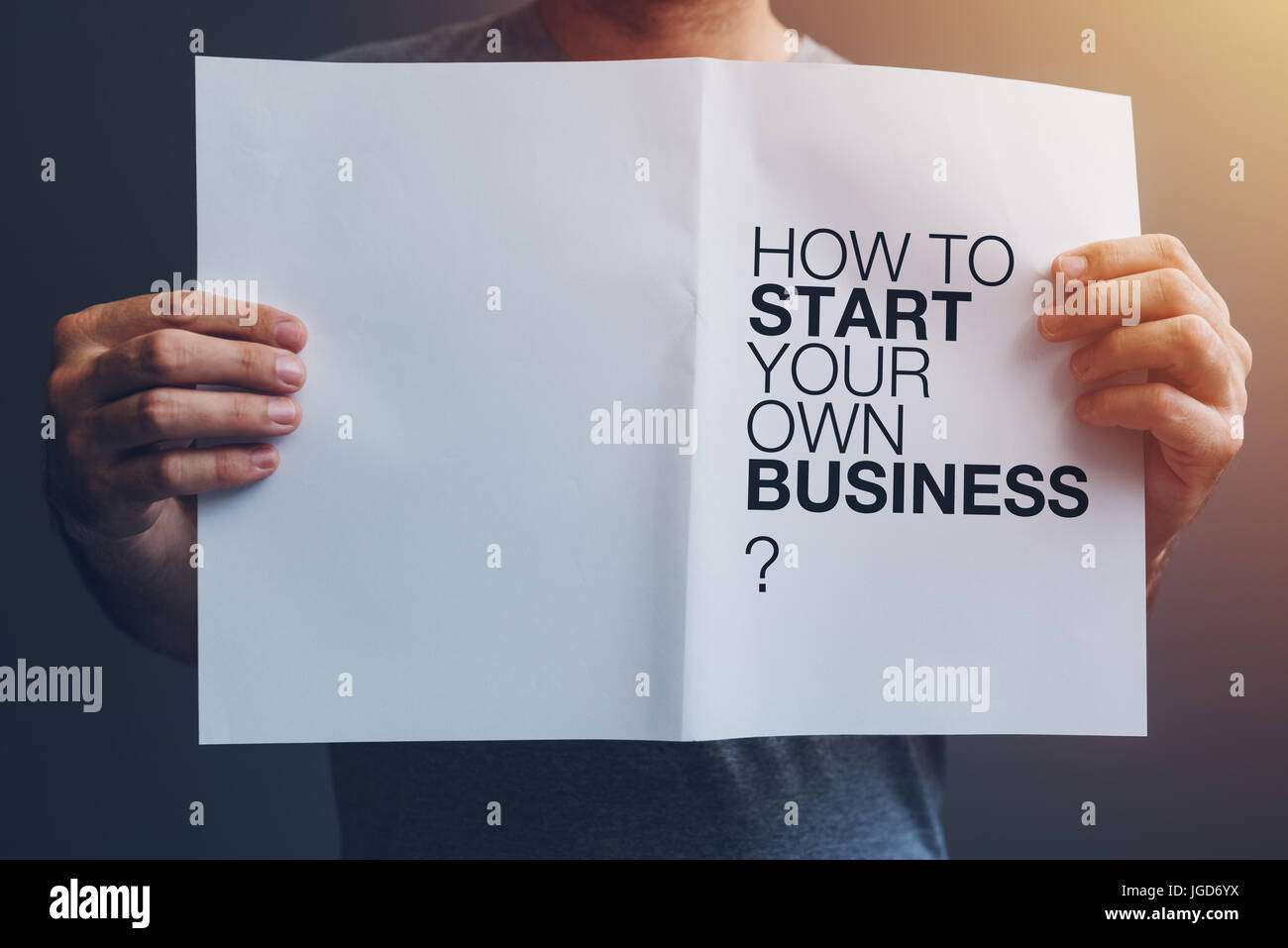 How to start your own business guide in male hands Stock Photo