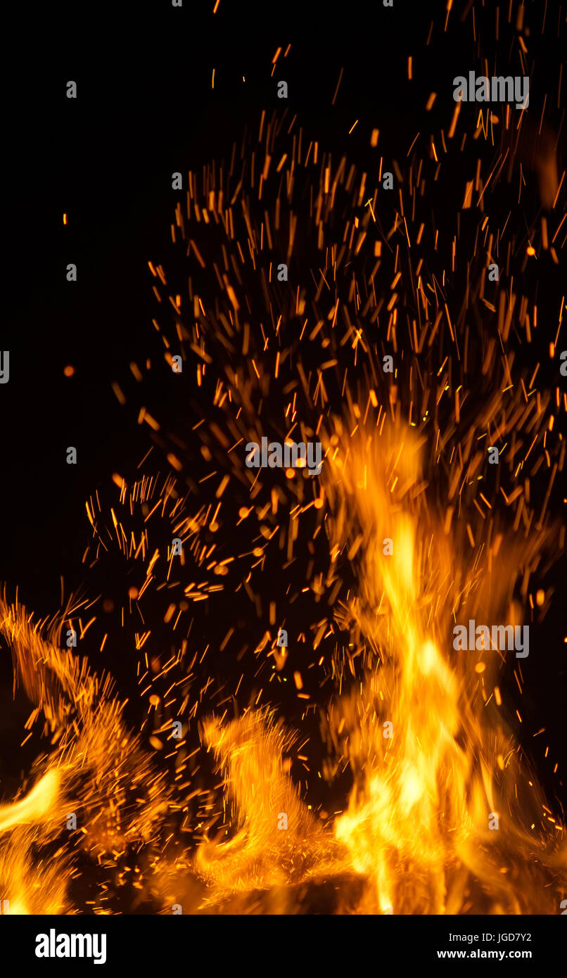 fire flames with sparks on black background Stock Photo - Alamy