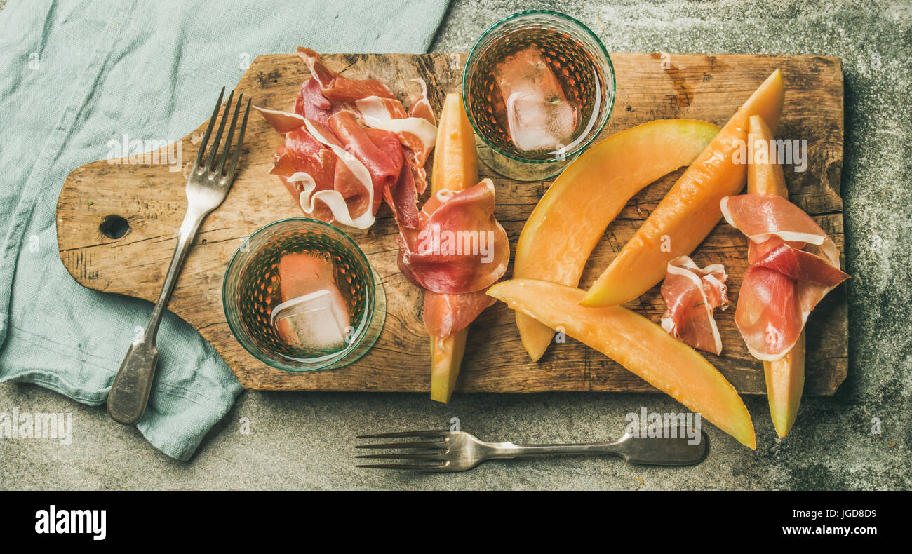 Flatlay of rose wine, prosciutto ham, melon, top view Stock Photo Alamy