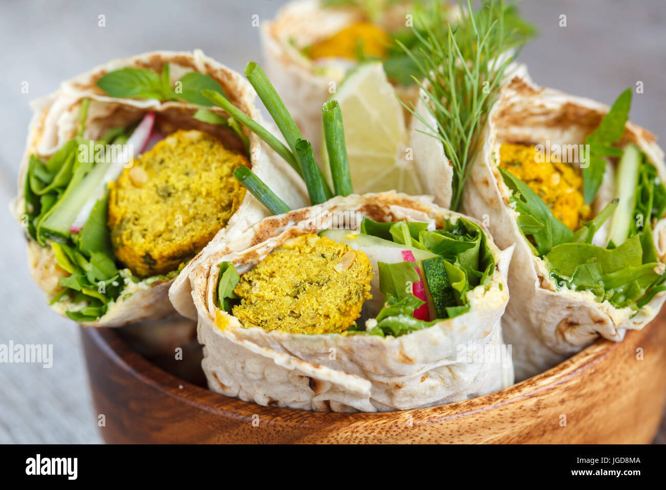 Vegan falafel wraps with salad and hummus. Love for a healthy vegan food concept. Stock Photo