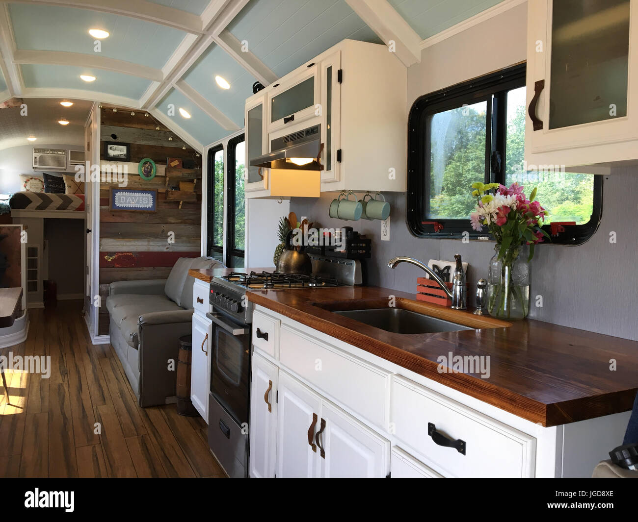 MEET the family who spent more than £23K converting their iconic American school bus into an off-grid mobile home complete with extended ceiling as th Stock Photo