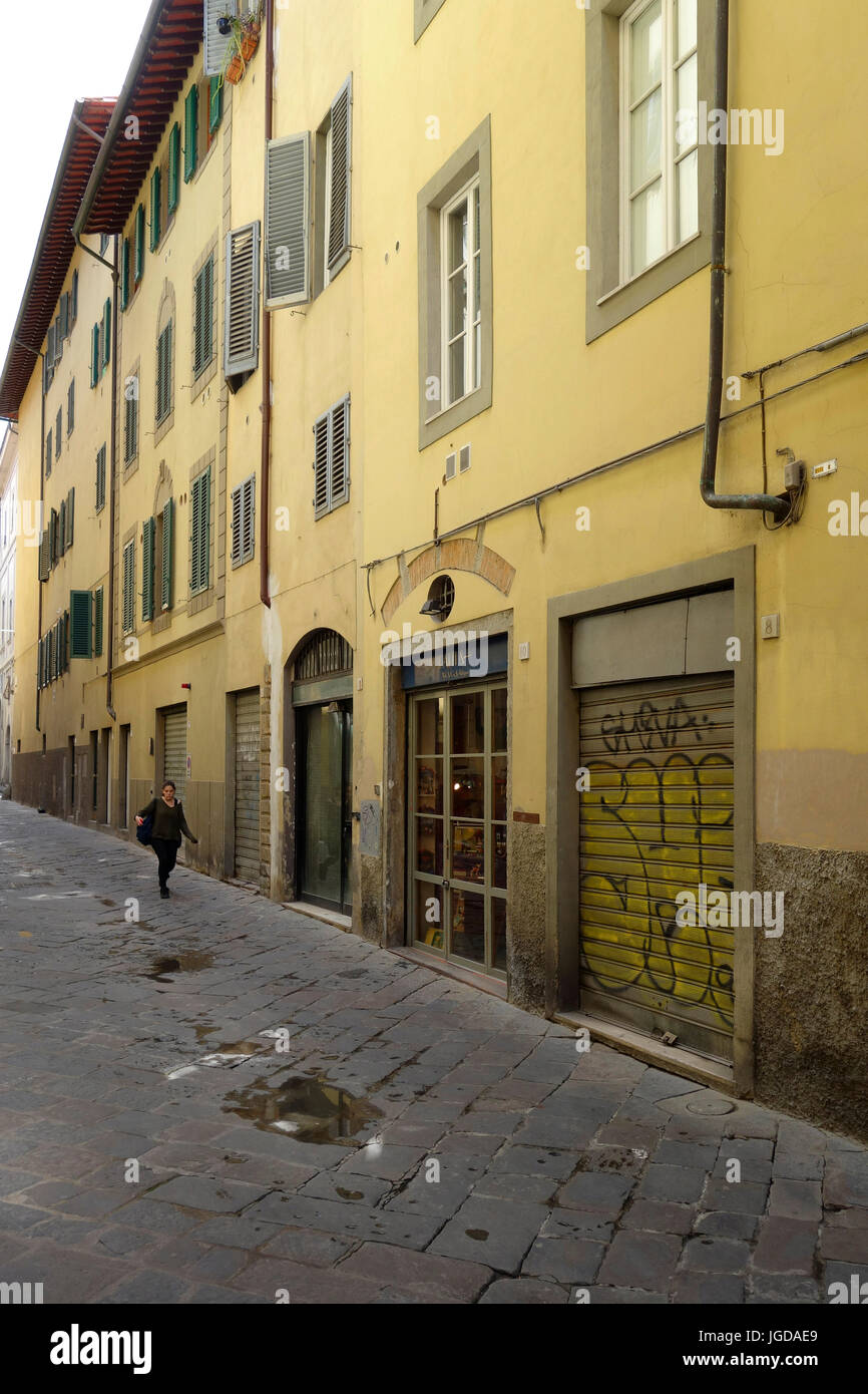 Woman walking down a side street, Florence, Italy Stock Photo