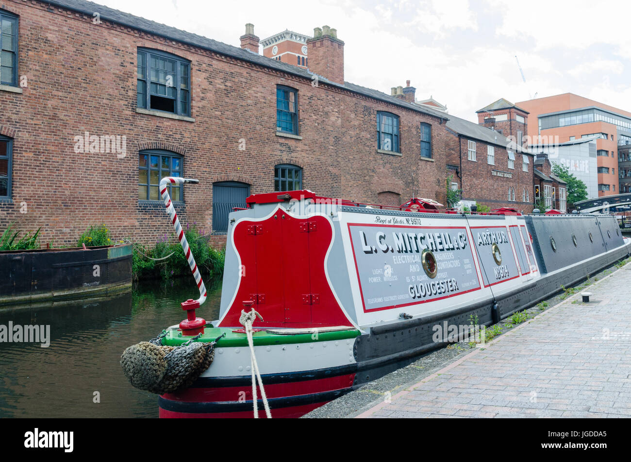 Colourful narrowboat on the canal running through Birmingham at Brindley Place Stock Photo