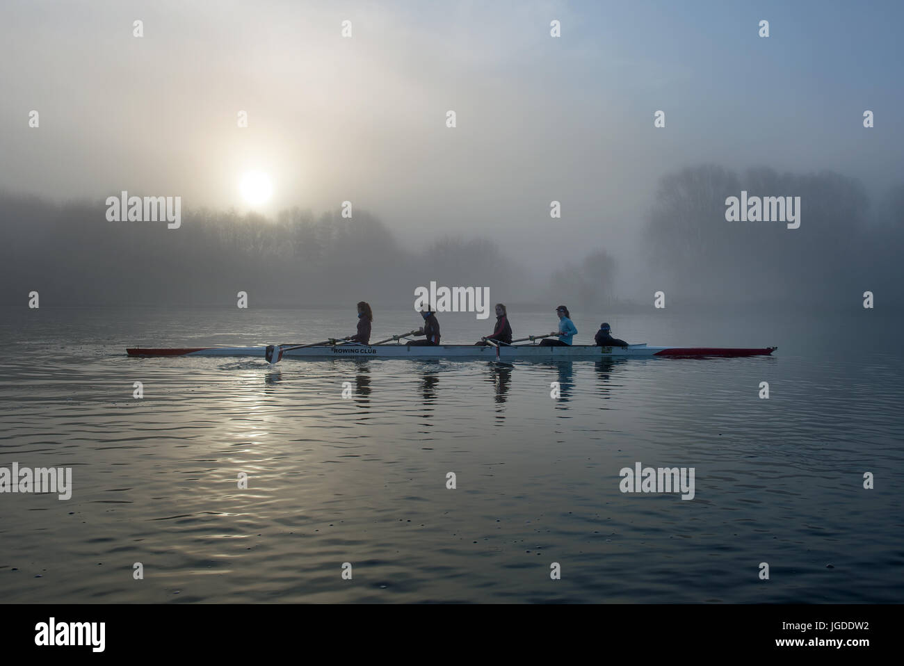 Rowers on a misty lake Stock Photo