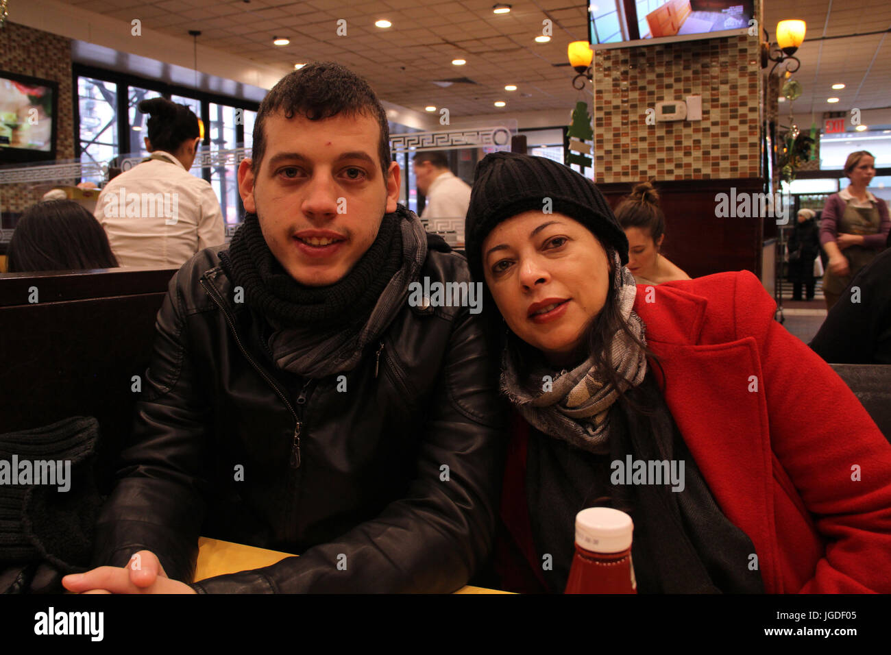 Family inside Coffee Shop, Times Square, New York, United States Stock