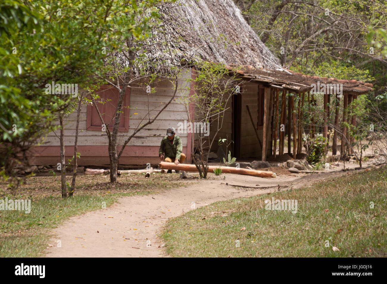Old man wokring with a machete in a wooden house Trinidad, Cuba Stock